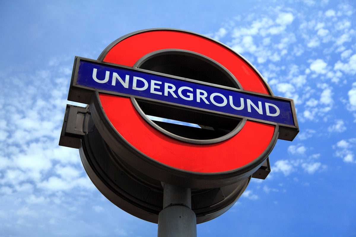 Close-up of a London Underground sign against a blue sky
